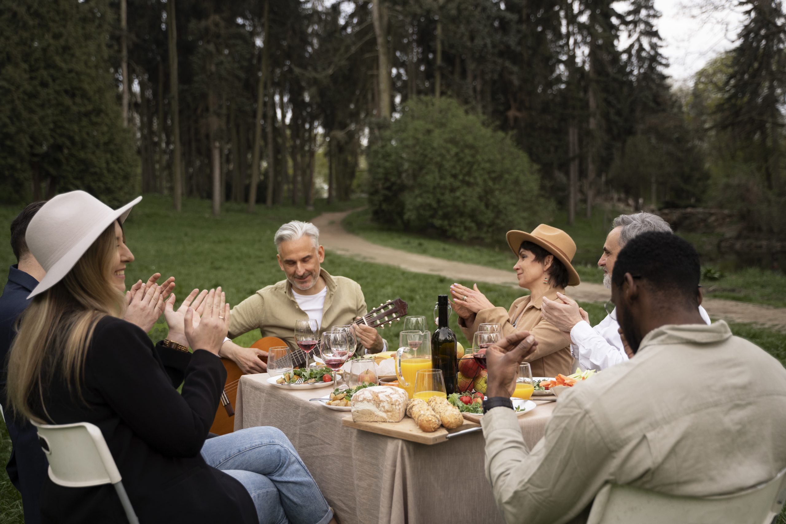 medium-shot-people-celebrating-together People sitting around a table, laughing and enjoying a meal