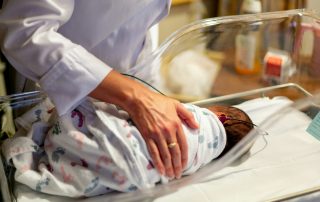 infant in ICU hospital bed