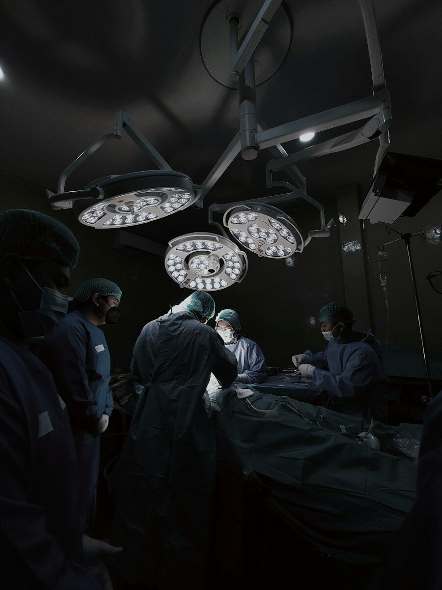 A group of doctors standing around a hospital bed